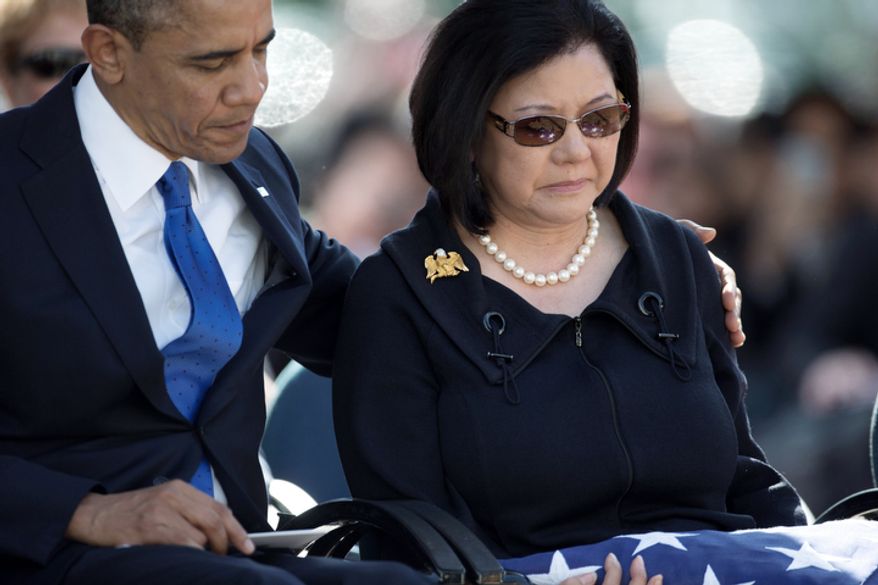 President Barack Obama, left, comforts Irene Hirano Inouye, the widow of the late Sen. Daniel Inouye, D-Hawaii, during a memorial service for the late senator, at the National Memorial Cemetery of the Pacific, Sunday, Dec. 23, 2012, in Honolulu. The 88-year-old Inouye died of respiratory complications on Dec. 17. (AP Photo/Carolyn Kaster)