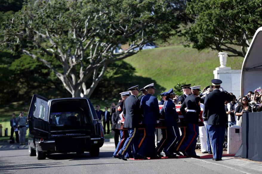 An honor guard carries the casket Sen. Daniel Inouye, D-Hawaii, at his memorial Service, at the Punchbowl National Memorial Cemetery of the Pacific in Honolulu, Sunday, Dec. 23, 2012. (AP Photo/Gerald Herbert)