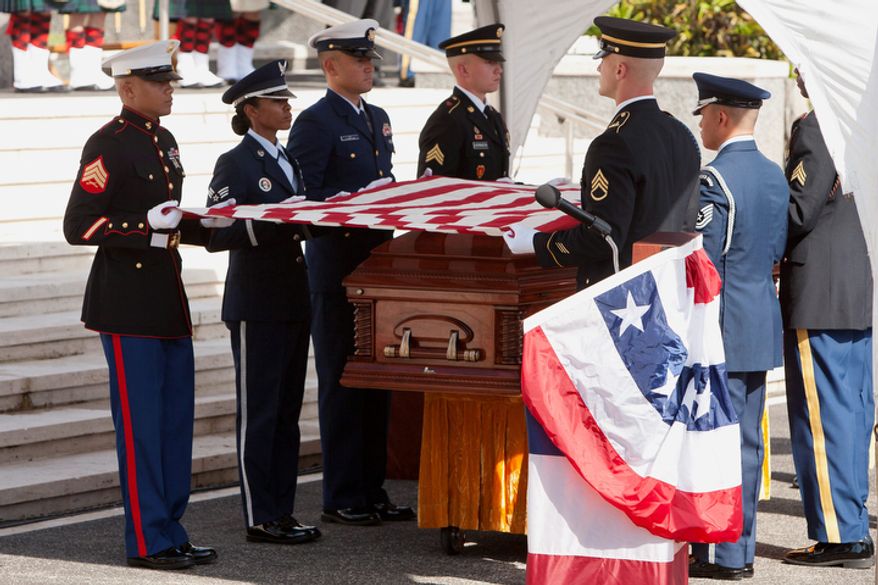 A U.S. military honor guard folds the flag over the coffin of U.S. Senator Daniel Inouye, D-Hawaii, during a memorial service at the National Memorial Cemetery of the Pacific, Sunday, Dec. 23, 2012 in Honolulu. (AP Photo/Marco Garcia)