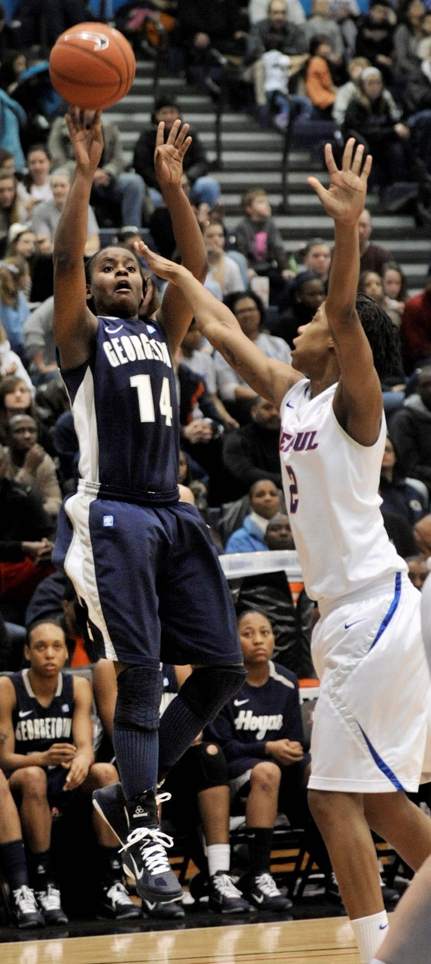 Georgetown's Sugar Rodgers left, goes up for a shot against DePaul's Taylor Pikes in the second half during an NCAA college basketball game in Chicago, Sunday, Feb. 20, 2011. DePaul won 82-57. (AP Photo/Paul Beaty)