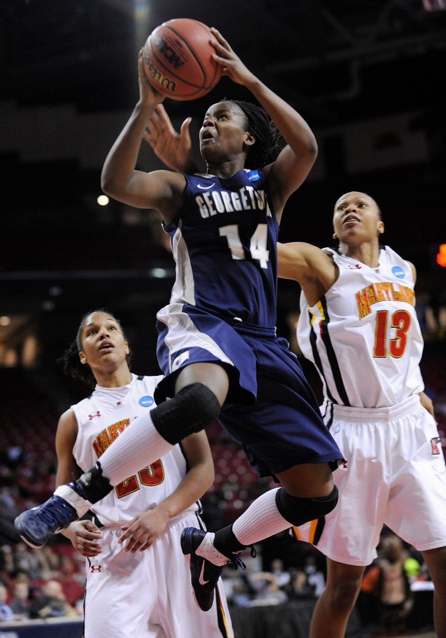Georgetown's Sugar Rodgers shoots as Maryland's Alicia DeVaugh, right, and Alyssa Thomas defend during the second half of a second-round game in the NCAA women's college basketball tournament Tuesday, March 22, 2011, in College Park, Md. Georgetown won 79-57. (AP Photo/Gail Burton)