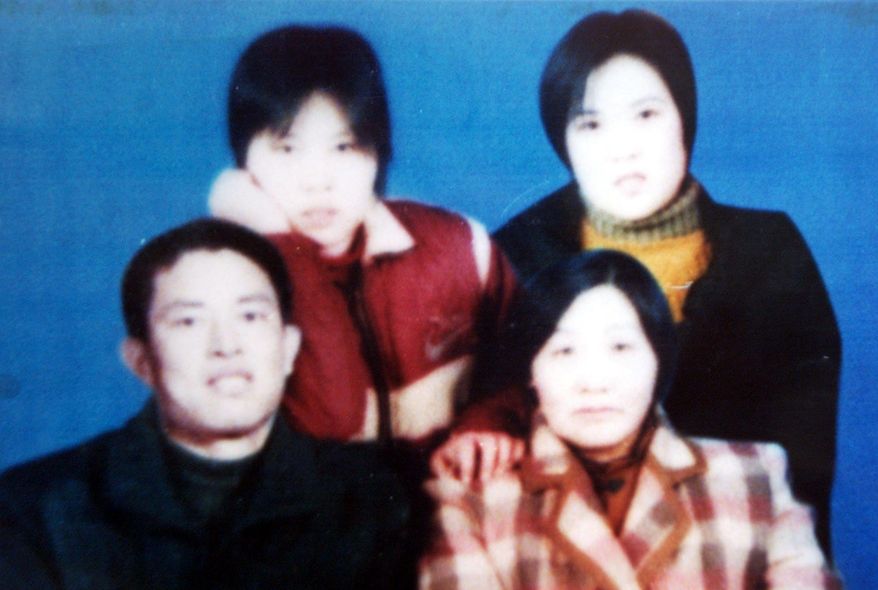 Chinese Christian preacher Gong Shengliang (bottom left) is seen with unidentified family members in an undated photograph. Relatives and two of his followers are seeking his release from prison after he apparently suffered a stroke.(Associated Press)
