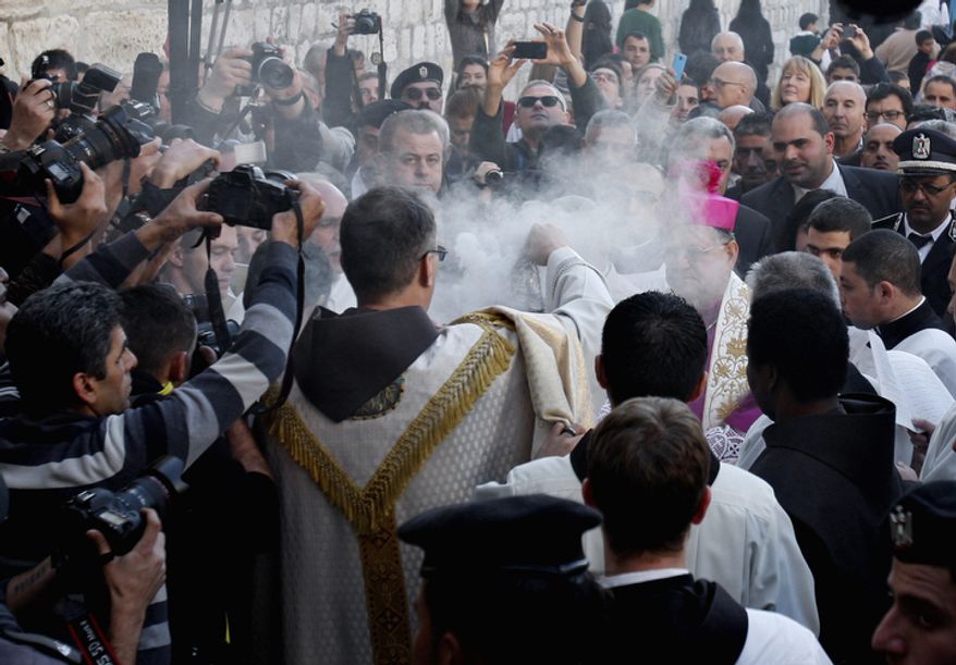 Latin Patriarch of Jerusalem Fouad Twal, center right, attends Christmas celebrations in the West Bank town of Bethlehem, Monday, Dec. 24, 2012. Twal, the top Roman Catholic cleric in the Holy Land, has celebrated the United Nations' recent recognition of a Palestinian state in his annual pre-Christmas remarks.(AP Photo/Adel Hana)