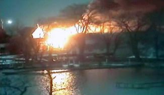 Two volunteer firefighters were shot to death and two others were wounded when they responded to a lakeshore house fire before dawn on Monday, Dec. 24, 2012, in Webster, N.Y. (AP Photo/WHAM-TV via AP video)