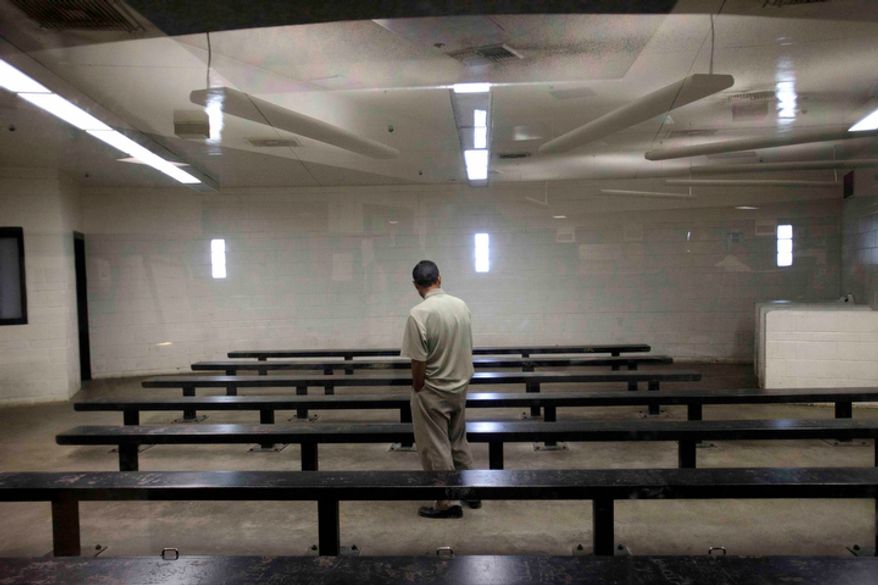 A man waits to be processed at a Border Patrol detention center in Imperial Beach, Calif., on Wednesday, Jan. 11, 2012. With border crossings at a 40-year low, the U.S. Border Patrol announced a new strategy on Tuesday, May 8, 2012, that targets repeat crossers and tries to find out why they keeping coming. (AP Photo/Gregory Bull)