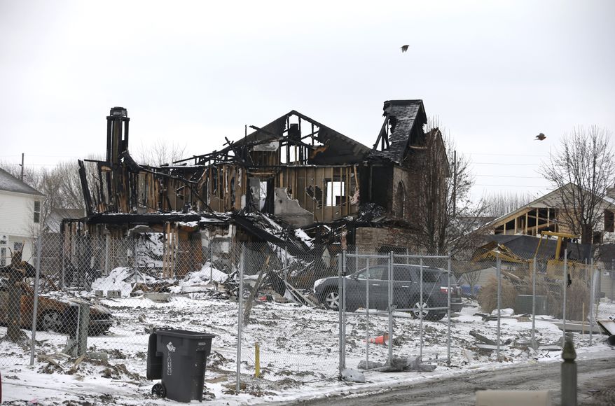 A house in the Richmond Hills neighborhood on the south side of Indianapolis was destroyed in an explosion that prosecutors say was set by the homeowner, her boyfriend and his brother. (AP Photo/Darron Cummings)