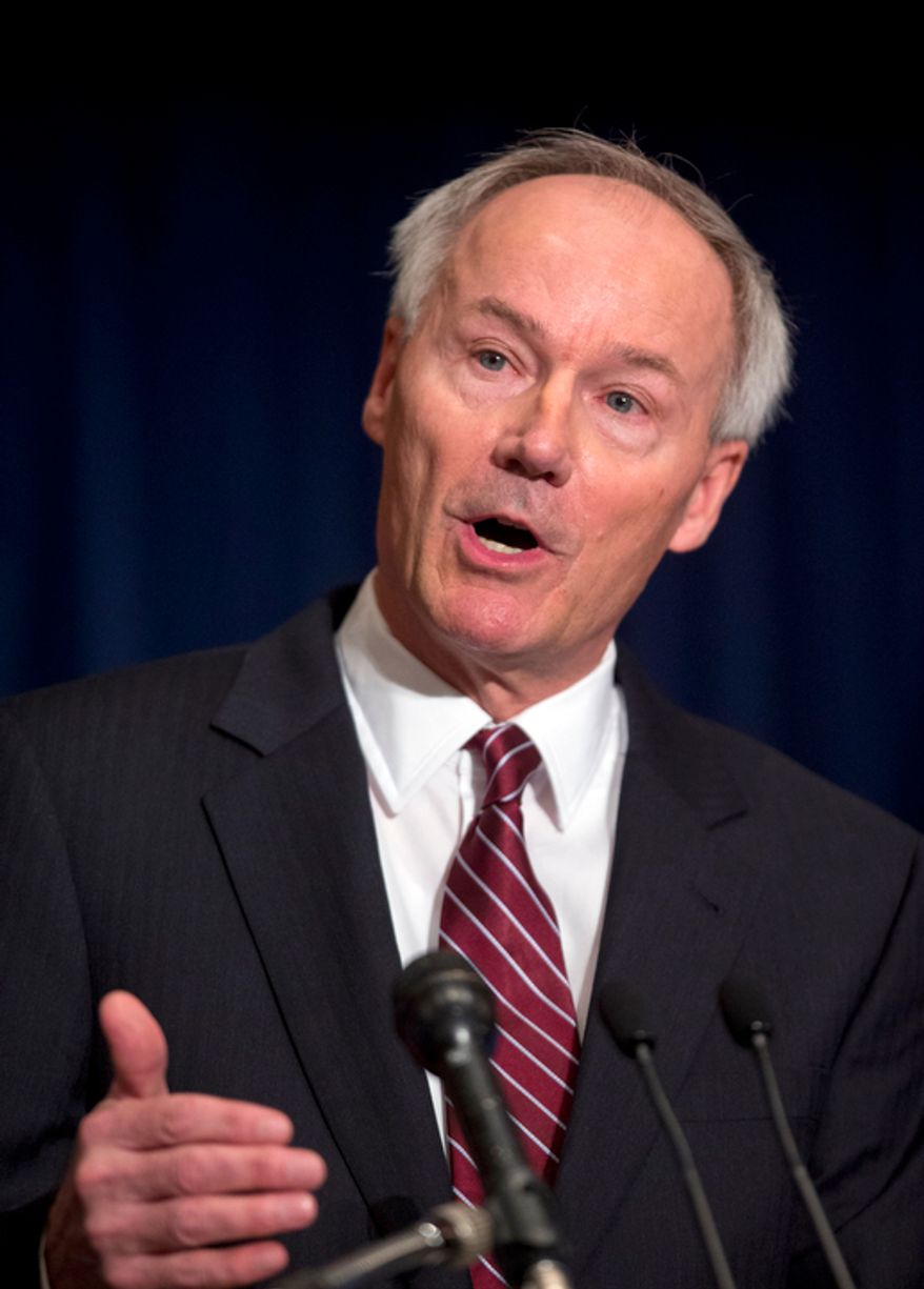 Former Rep. Asa Hutchison, Arkansass Republican, gestures as he speaks during a news conference in response to the Connecticut school shooting on Friday, Dec. 21, 2012, in Washington. Mr. Hutchinson will lead an National Rifle Association program that will develop a model security plan for schools that relies on armed volunteers. (AP Photo/ Evan Vucci)