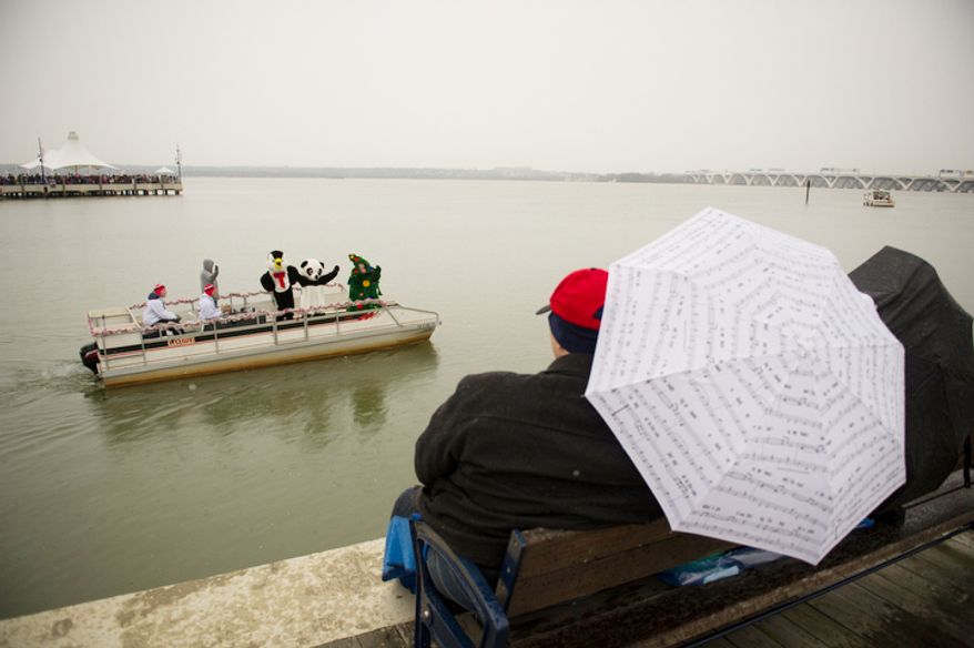 People brave the cold, rain and snow during the 27th annual show of The Water-Skiing Santa. (Rod Lamkey Jr./The Washington Times)