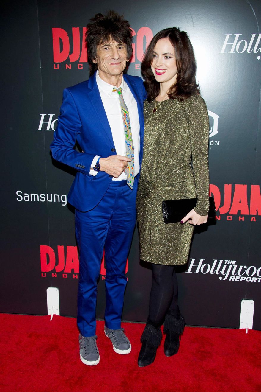 Rolling Stones guitarist Ronnie Wood, 65, and Sally Humphries, 34, a theater producer, got married Friday, Dec. 21, 2012, in a private ceremony in London. (Associated Press)