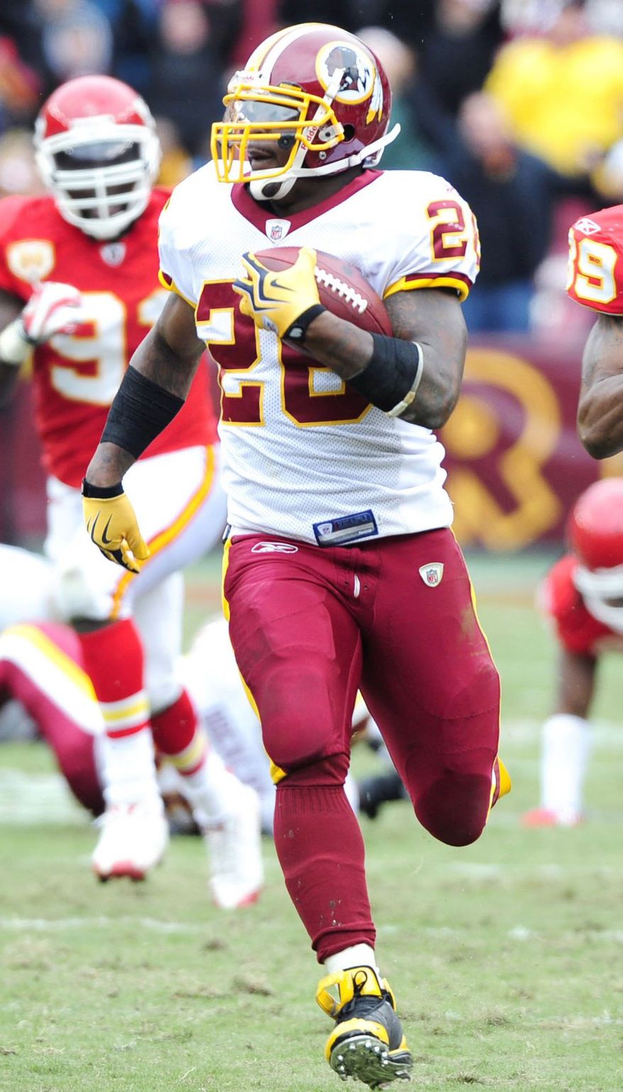 Clinton Portis (left) and Stephen Davis own four of the top five rushing seasons in Redskins history. Rookie Alfred Morris, a sixth-round draft pick, would have the best should he run for 104 yards Sunday night against Dallas. (The Washington Times)