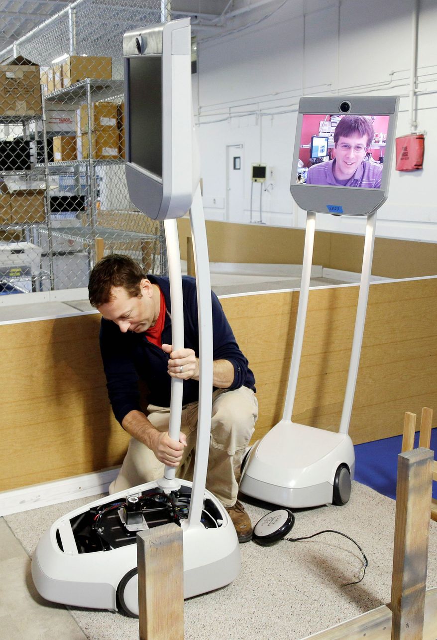 Engineer Christian Carlberg runs the Beam through an obstacle course with help from fellow engineer Dallas Goecker (on screen). (Associated Press)