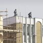 Afghan policemen keep watch from atop city police headquarters in Kabul, Afghanistan, on Monday, Dec. 24, 2012, following the killing of an American adviser by an Afghan policewoman, according to a senior Afghan police official. (AP Photo/Musadeq Sadeq)