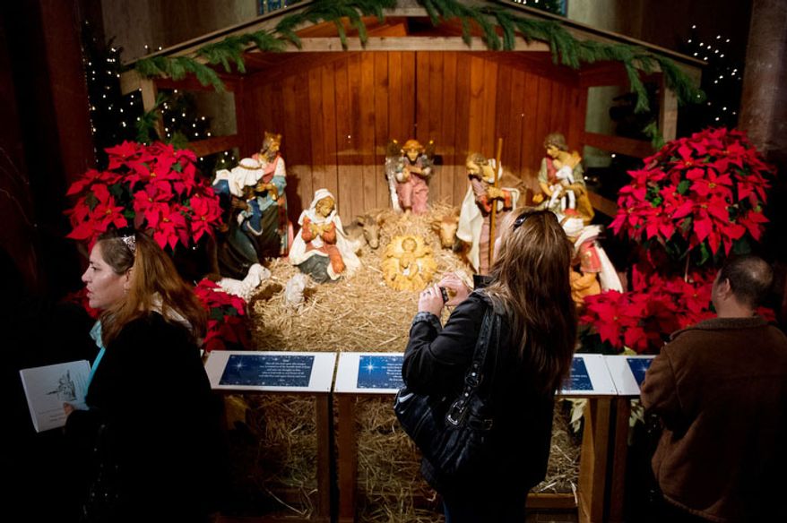 Church attendees get a look at a Christmas manger scene before Archbishop of Washington Cardinal Donald Wuerl leads a congregation of 4,000 in Solemn Mass of Christmas Day at the Basilica of the National Shrine of the Immaculate Conception, Washington, D.C., Tuesday, December 25, 2012. (Andrew Harnik/The Washington Times)