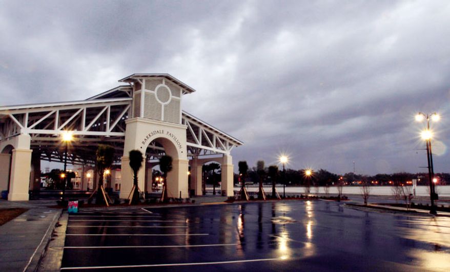 Storm clouds roll past Barksdale Pavilion at Jones Park in Gulfport, Miss., Tuesday, Dec. 25, 2012. After most of spending Christmas Day with a blustery day and occasional blue skies, storm clouds arrived on the Coast at 4 p. m. The strong south breeze blew most of the bad weather north of the immediate coast line. (AP Photo/The Sun Herald, Tim Isbell)