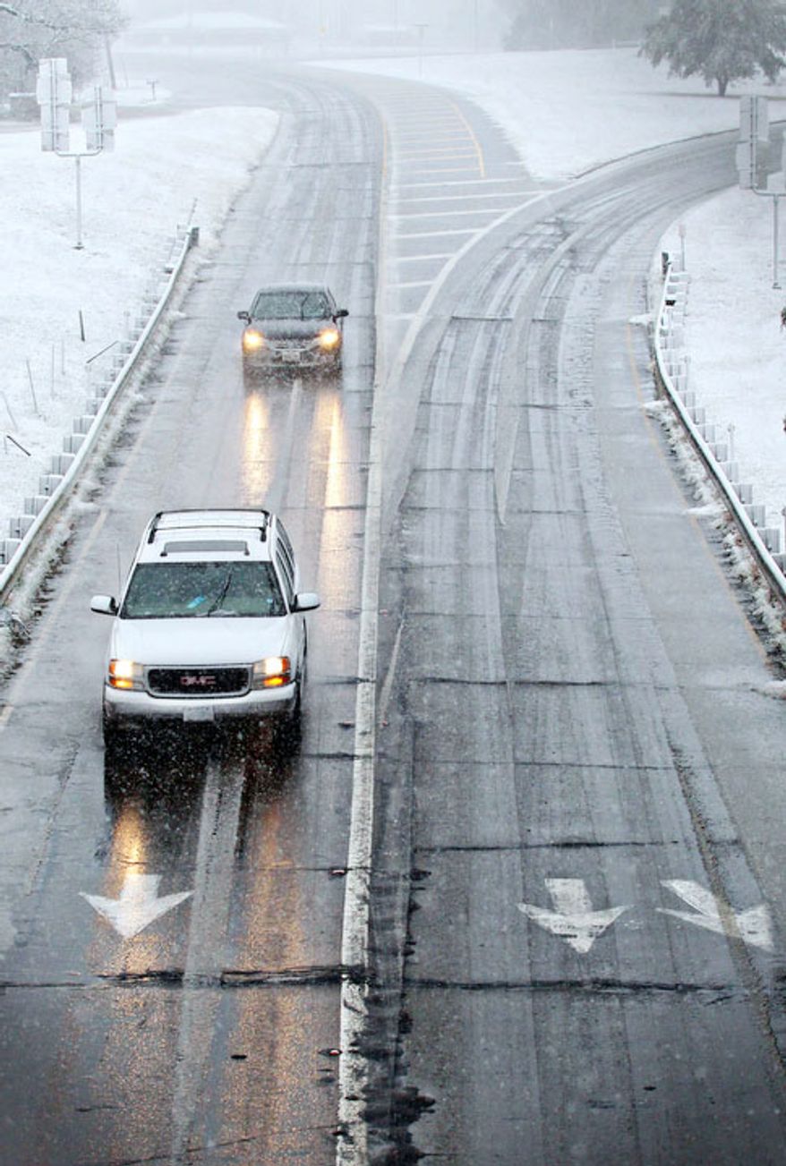 Drivers maneuver wet and icy roads in Paris, Texas Tuesday, Dec. 25, 2012 after a strong winter system dropped inches of rain and snow on most of North East Texas. (AP Photo/The Paris News, Sam Craft)