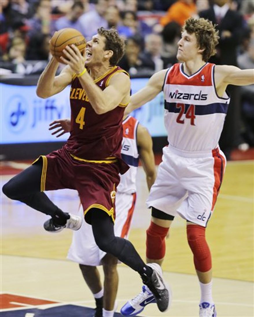 Cleveland Cavaliers forward Luke Walton (4) shoots past Washington Wizards forward Jan Vesely (24) in the second half of an NBA game, Wednesday, Dec. 26, 2012, in Washington. The Cavaliers won 87-84. (AP Photo/Alex Brandon)