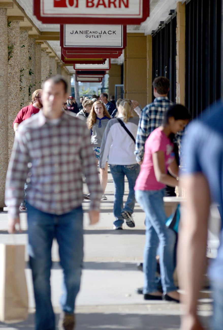 Shoppers browse store fronts at Silver Sands Premium Outlets on Wednesday Dec. 26, 2012 in Destin, Fla. (AP Photo/ Northwest Florida Daily News, Nick Tomecek)