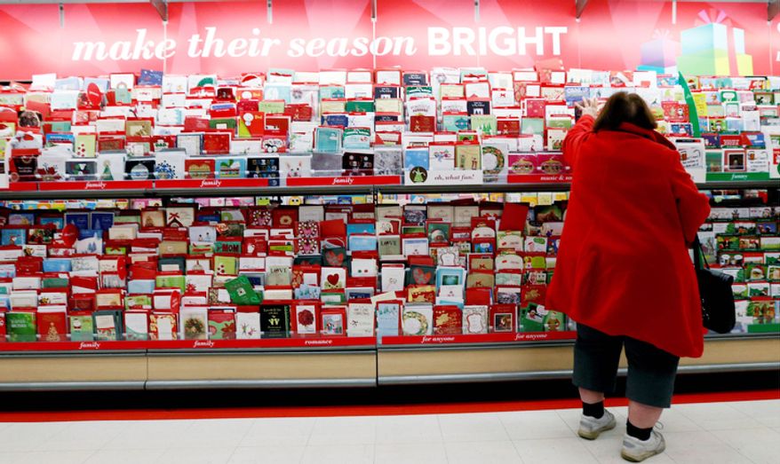 In this Wednesday, Dec. 19, 2012, photo, a customer shops for greeting cards at a Target store in Chicago. U.S. holiday retail sales this year are the weakest since 2008, after a shopping season disrupted by storms and rising uncertainty among consumers. (AP Photo/Nam Y. Huh)