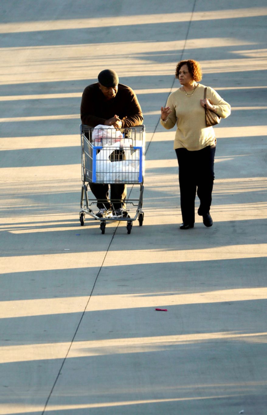 In this Tuesday, Dec. 18, 2012, file photo, shoppers push a cart with merchandise at a Walmart Supercenter store in Little Rock, Ark. U.S. holiday retail sales this year are the weakest since 2008, after a shopping season disrupted by storms and rising uncertainty among consumers. (AP Photo/Danny Johnston)