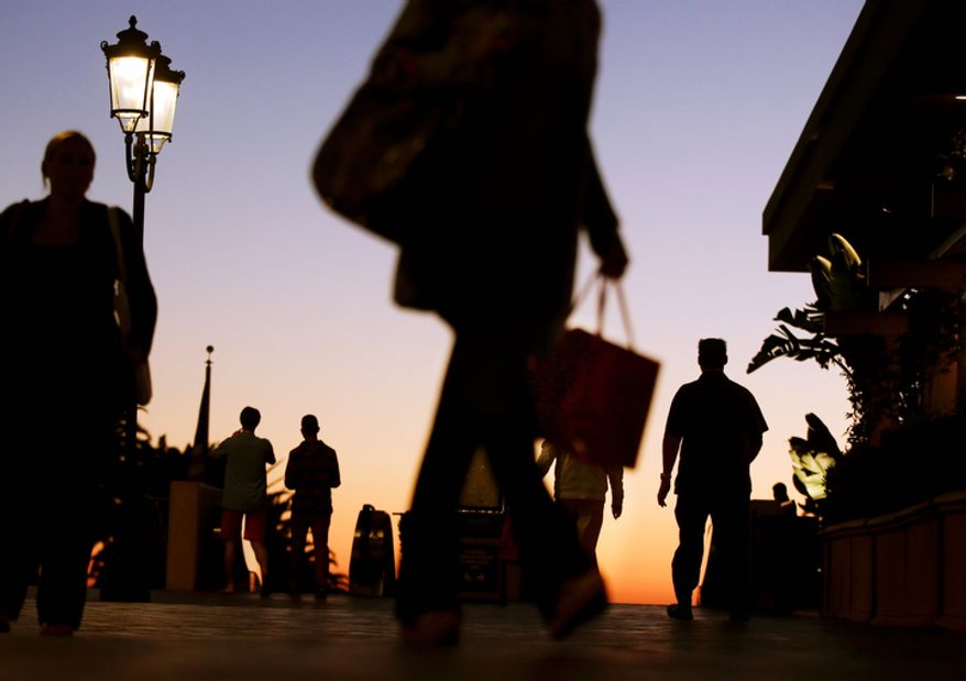 In this Thursday, Dec. 20, 2012 photo, people walk through the Fashion Island shopping center in Newport Beach, Calif. U.S. holiday retail sales this year are the weakest since 2008, after a shopping season disrupted by storms and rising uncertainty among consumers. (AP Photo/Chris Carlson, File)