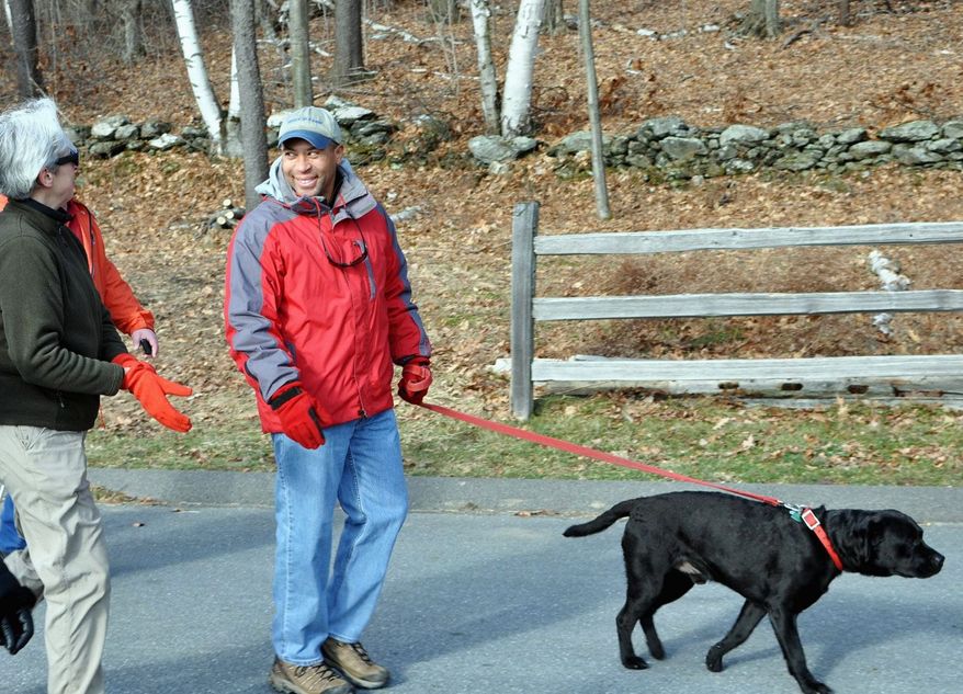 In a First Day Hike last Jan. 1, Massachusetts Gov. Deval Patrick and his dog Tobey step out at Mount Greylock State Reservation. (Associated Press)