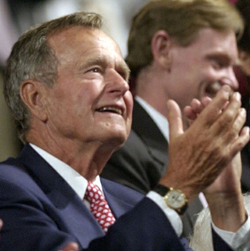 Former President George H. W. Bush applauds during the evening session of the first day of the Republican National Convention Monday, Aug. 30, 2004, in New York. (AP Photo/Charlie Riedel)
