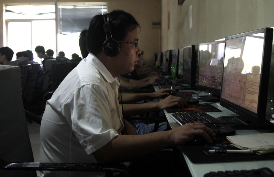 ** FILE ** A Chinese man uses a computer at an Internet cafe in Beijing in 2010. (Associated Press)