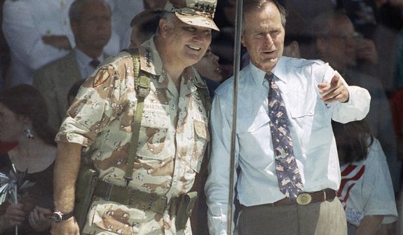 **FILE** Gen. Norman Schwarzkopf and President George Bush watch the National Victory Parade from the viewing stand in Washington on June 8, 1991. Schwarzkopf led his troops in the parade, and then joined Bush in the reviewing stand. (Associated Press)