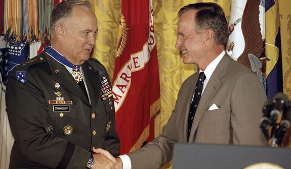 **FILE** President George Bush congratulates Desert Storm commander Gen. Norman Schwarzkopf after presenting him with the Medal of Freedom at the White House in Washington on July 4, 1991. (Associated Press)