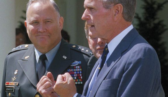 **FILE** Gen. Norman Schwarzkopf (left) looks on as President George Bush speaks to reporters in the Rose Garden of the White House on April 23, 1991. Bush praised the general for leading a &quot;fantastic&quot; effort to fulfill U.S. obligations in the Gulf and for helping to build &quot;unbelievable&quot; morale on the home front. (Associated Press)