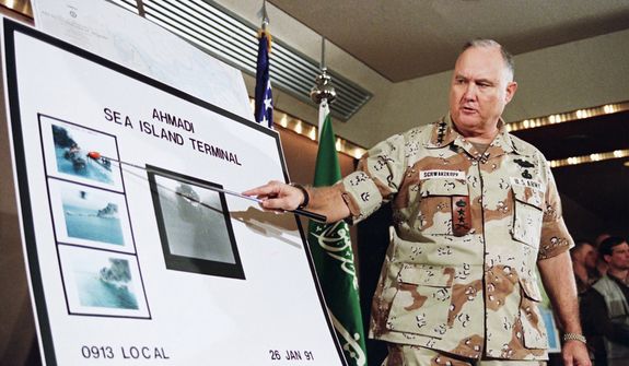 **FILE** U.S. Army Gen. Norman Schwarzkopf points Jan. 27, 1991, to a row of photos of Kuwait&#39;s Ahmadi Sea Island Terminal on fire after a U.S. attack on the facility. (Associated Press)