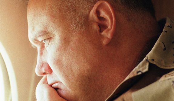 **FILE** Gen. H. Norman Schwarzkopf, commander of U.S. troops in the Gulf, gazes from the window of a small jet on his way out to visit U.S. troops in the desert in Saudi Arabia on Jan. 13, 1991. (Associated Press)