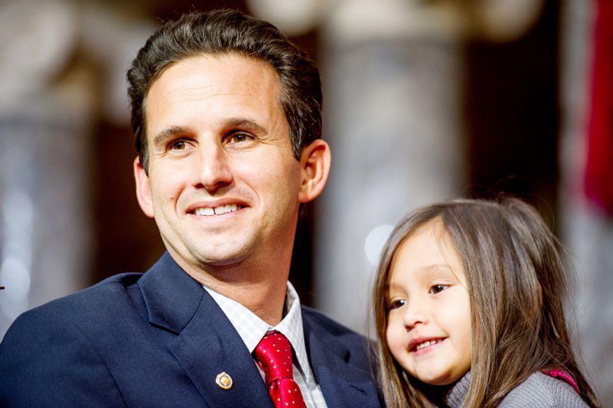 Brian Emanuel Schatz (D-Hawaii) smiles with his daughter Mia, 4, after re-enacting his swearing in ceremony with Vice President Joe Biden inside the old Senate Chamber at the U.S. Capitol Building, Washington, D.C., Thursday, December 27, 2012. Schatz, who was the Lt. Gov. for Hawaii was selected by Hawaii Gov. Neil Abercrombie to the U.S. Senate seat left vacant by the late Daniel K. Inouye. (Andrew Harnik/The Washington Times)