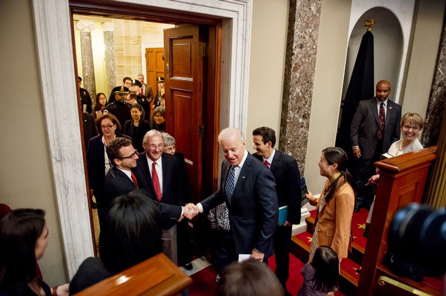 Vice President Joe Biden greets the family of Brian Emanuel Schatz (D-Hawaii), center right, before re-enacting Schatz's swearing in ceremony inside the old Senate Chamber at the U.S. Capitol Building, Washington, D.C., Thursday, December 27, 2012. Schatz, who was the Lt. Gov. for Hawaii was selected by Hawaii Gov. Neil Abercrombie to the U.S. Senate seat left vacant by the late Daniel K. Inouye. (Andrew Harnik/The Washington Times)
