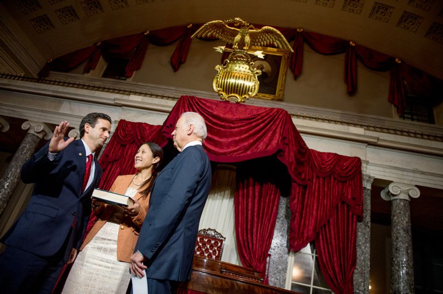 Linda Schatz, center, watches as her husband, Brian Emanuel Schatz (D-Hawaii), re-enacts his swearing in ceremony with Vice President Joe Biden inside the old Senate Chamber at the U.S. Capitol Building, Washington, D.C., Thursday, December 27, 2012. Schatz, who was the Lt. Gov. for Hawaii was selected by Hawaii Gov. Neil Abercrombie to the U.S. Senate seat left vacant by the late Daniel K. Inouye. (Andrew Harnik/The Washington Times)