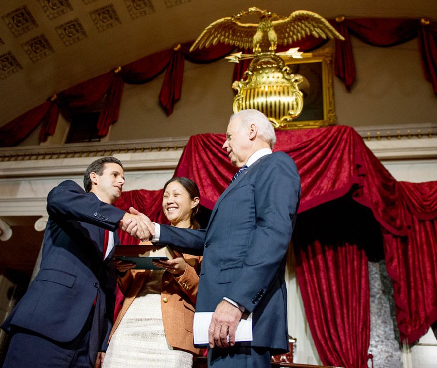 Linda Schatz, center, watches as her husband, Brian Emanuel Schatz (D-Hawaii), re-enacts his swearing in ceremony with Vice President Joe Biden inside the old Senate Chamber at the U.S. Capitol Building, Washington, D.C., Thursday, December 27, 2012. Schatz, who was the Lt. Gov. for Hawaii was selected by Hawaii Gov. Neil Abercrombie to the U.S. Senate seat left vacant by the late Daniel K. Inouye. (Andrew Harnik/The Washington Times)