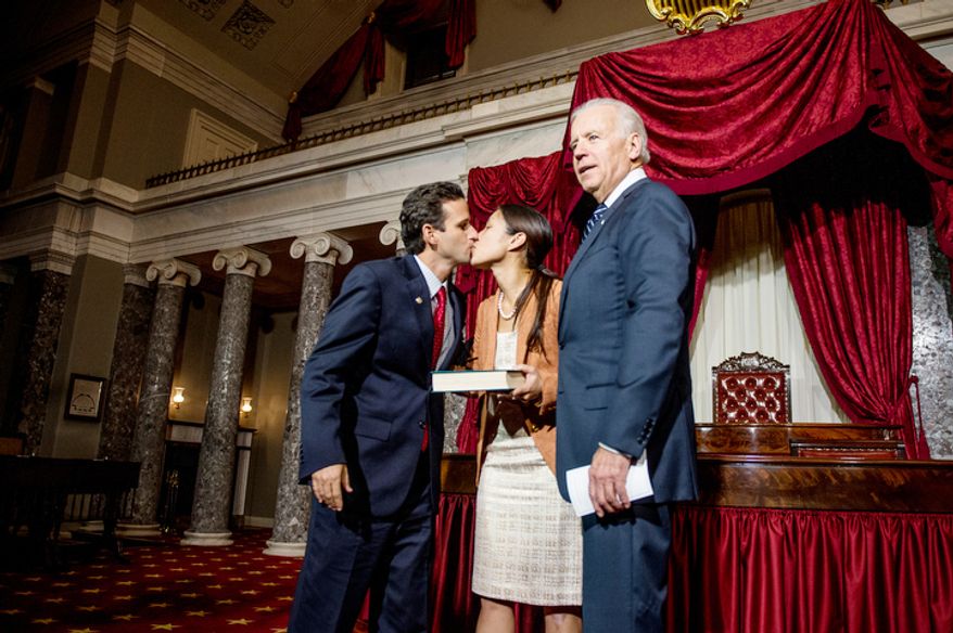 Brian Emanuel Schatz (D-Hawaii), kisses his wife, Linda, after re-enacting his swearing in ceremony with Vice President Joe Biden inside the old Senate Chamber at the U.S. Capitol Building, Washington, D.C., Thursday, December 27, 2012. Schatz, who was the Lt. Gov. for Hawaii was selected by Hawaii Gov. Neil Abercrombie to the U.S. Senate seat left vacant by the late Daniel K. Inouye. (Andrew Harnik/The Washington Times)
