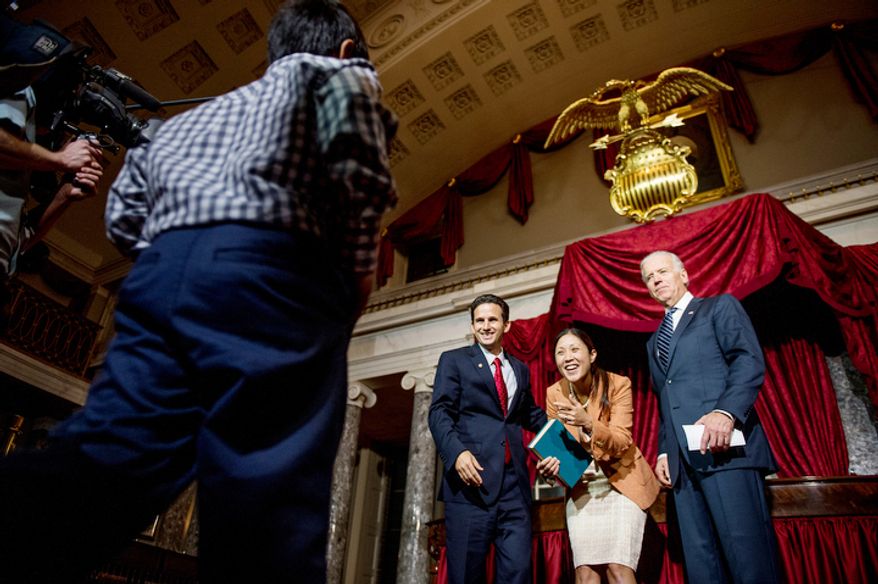 Brian Emanuel Schatz (D-Hawaii) and his wife Linda motion for their son Tyler, 9, after re-enacting Schatz's swearing in ceremony with Vice President Joe Biden inside the old Senate Chamber at the U.S. Capitol Building, Washington, D.C., Thursday, December 27, 2012. Schatz, who was the Lt. Gov. for Hawaii was selected by Hawaii Gov. Neil Abercrombie to the U.S. Senate seat left vacant by the late Daniel K. Inouye. (Andrew Harnik/The Washington Times)