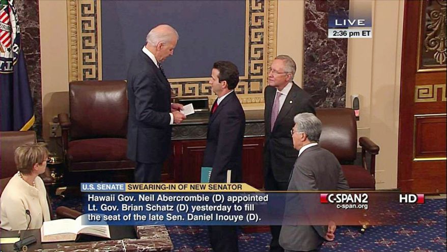 This handout video frame grab image provided by C-SPAN2 shows Vice President Joe Biden, left, administering the Senate Oath to Hawaii's newest Sen. Brian Schatz, center, as Senate Majority Leader Harry Reid of Nev., second from right, and retiring Hawaii Sen. Daniel Akaka, right, watch, Thursday, Dec. 27, 2012, on the Senate floor on Capitol Hill in Washington, Dec. 27, 2012, Schatz replaces Sen. Daniel Inouye, D-Hawaii who died last week. Akaka is retiring and will be succeeded by Rep. Mazie Hirono who was elected in November. (AP Photo/C-SPAN2)