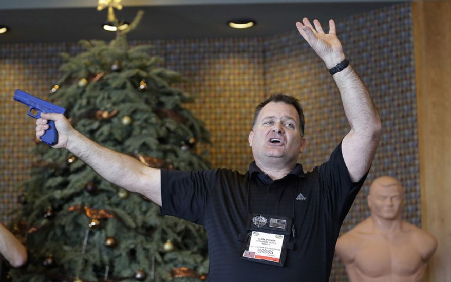 Clark Aposhian, president of Utah Shooting Sport Council, demonstrates with a plastic gun Dec. 27, 2012, during concealed-weapons training for 200 Utah teachers in West Valley City, Utah. The Utah Shooting Sports Council offered six hours of training in handling concealed weapons in the latest effort to arm teachers to confront school assailants. (Associated Press)