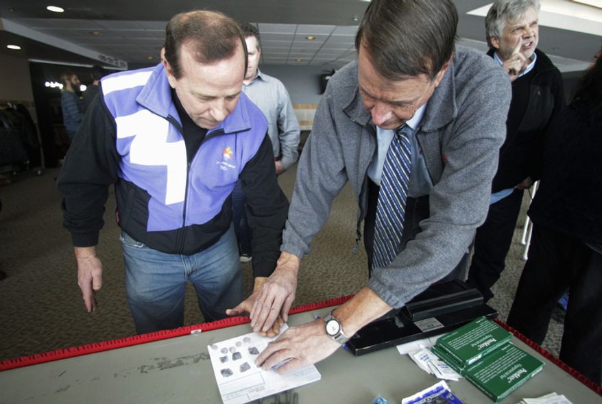 Stephen Pratt, a third-grade teacher from Alpine, Utah, is fingerprinted for a gun carry permit Dec. 27, 2012, during concealed-weapons training for 200 Utah teachers in West Valley City, Utah. The Utah Shooting Sports Council offered six hours of training in handling concealed weapons in the latest effort to arm teachers to confront school assailants. (Associated Press)