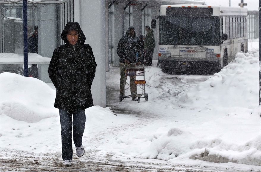 People walk in the snow in Buffalo, N.Y., Saturday, Dec. 29, 2012. A mild but widespread winter storm has developed over the Northeast and the upper Ohio River Valley, the second in less than a week for the regions. (AP Photo/Mel Evans)
