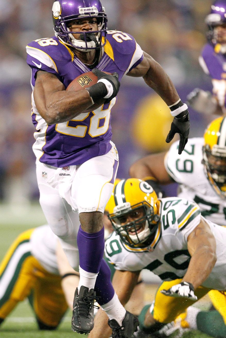 Minnesota's Adrian Peterson ran for 199 yards against Green Bay, finishing 9 yards shy of setting a single-season record for rushing yards. (Associated Press)