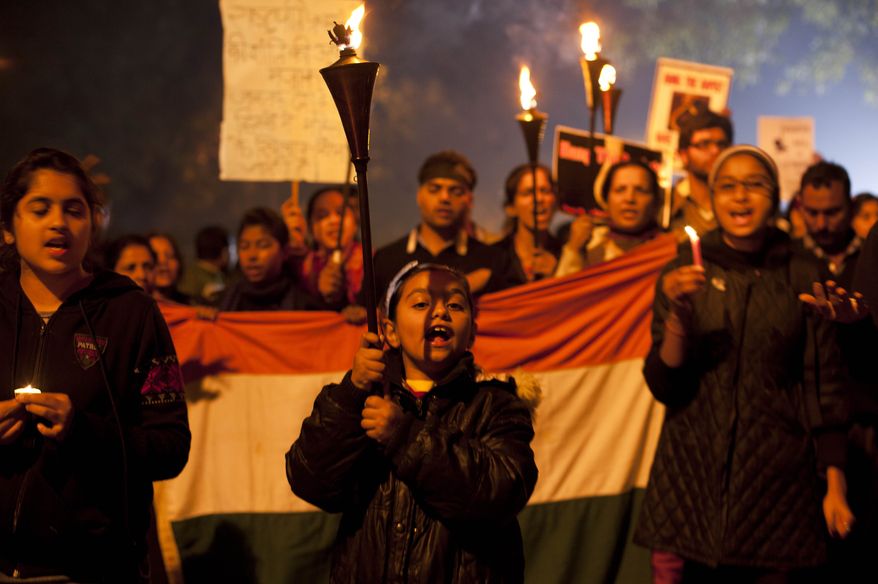 A young Indian girl leads a protest march in New Delhi on Saturday, Dec. 29, 2012, as demonstrators mourn the death of a gang-rape victim. Indian police charged six men with murder on Saturday, adding to accusations that they beat and gang-raped the woman on a New Delhi bus nearly two weeks ago in a case that has shocked the country. (AP Photo/Dar Yasin)
