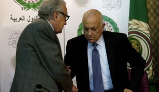 Lakhdar Brahimi (left), the U.N.-Arab League envoy to Syria, shakes hands with Arab League Secretary-General Nabil Elaraby following a joint press conference at the league&#39;s headquarters in Cairo on Sunday, Dec. 30, 2012. (AP Photo/Nasser Nasser)

