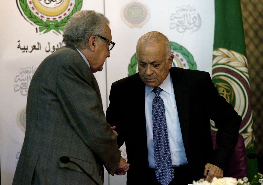 Lakhdar Brahimi (left), the U.N.-Arab League envoy to Syria, shakes hands with Arab League Secretary-General Nabil Elaraby following a joint press conference at the league's headquarters in Cairo on Sunday, Dec. 30, 2012. (AP Photo/Nasser Nasser)