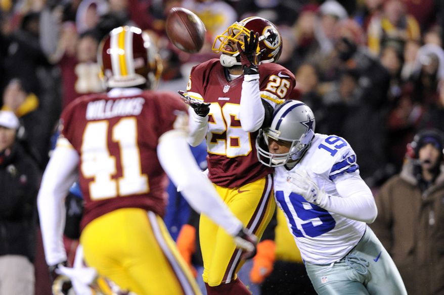 Washington Redskins cornerback Josh Wilson (26) intercepts a second-quarter pass intended for Dallas Cowboys wide receiver Miles Austin (19) at FedEx Field, Landover, Md., Dec. 30, 2012. (Preston Keres/Special to The Washington Times)