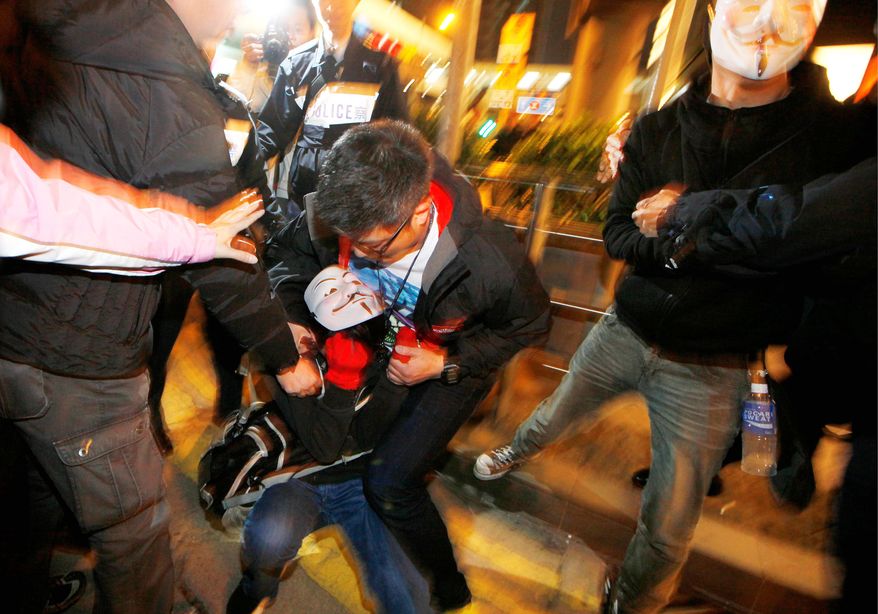 Police said 26,000 people joined the march at its peak Tuesday while organizers said 130,000 took part, with some demonstrators sporting Guy Fawkes masks. The protests came half a year after Mr. Leung, who was chosen by a 1,193-member committee, took office. (Associated Press)