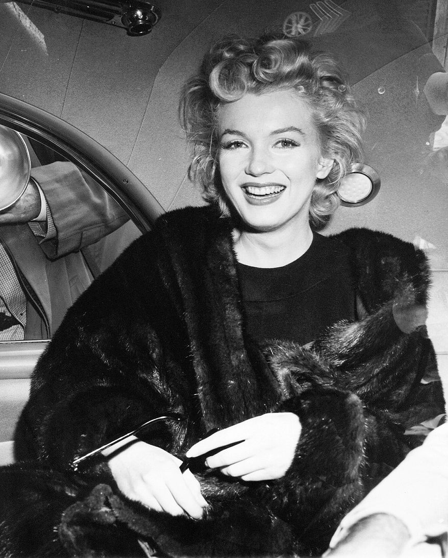 ** FILE ** Hollywood actress Marilyn Monroe smiles after arriving tousled from an overnight plane flight from Los Angeles to New York in this undated photo. (AP Photo)