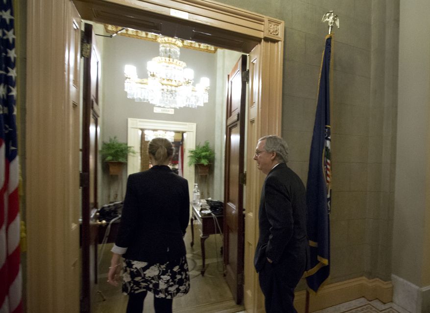 Senate Minority Leader Mitch McConnell (right), Kentucky Republican, returns to his office after a vote on the "fiscal cliff" deal on Capitol Hill on Tuesday, Jan. 1, 2013, in Washington. (AP Photo/Alex Brandon)
